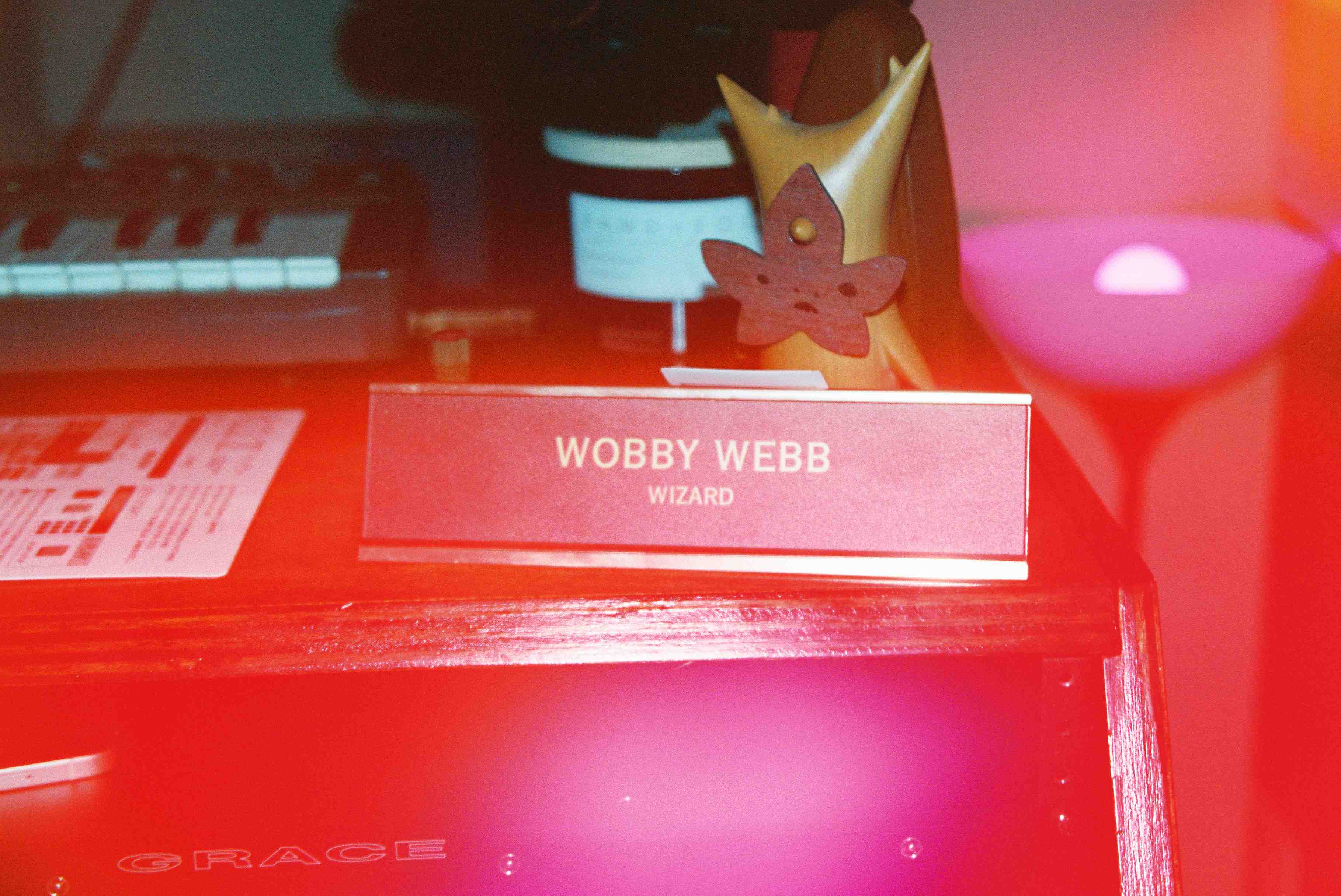 A desk name plate that says 'Wobby Webb'